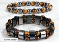 Green Aventurine and Tiger Eye money bracelet arranged in circle on dark wood